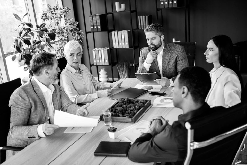 Healthcare leadership team meeting around a conference table